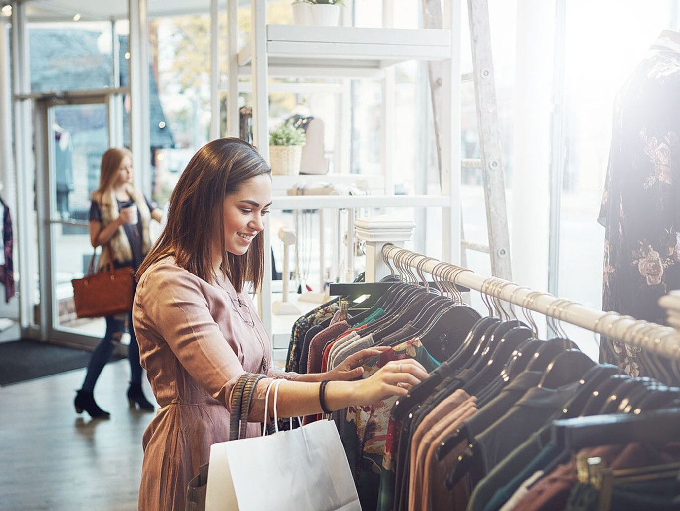 A woman looking at clothes in a clothing store