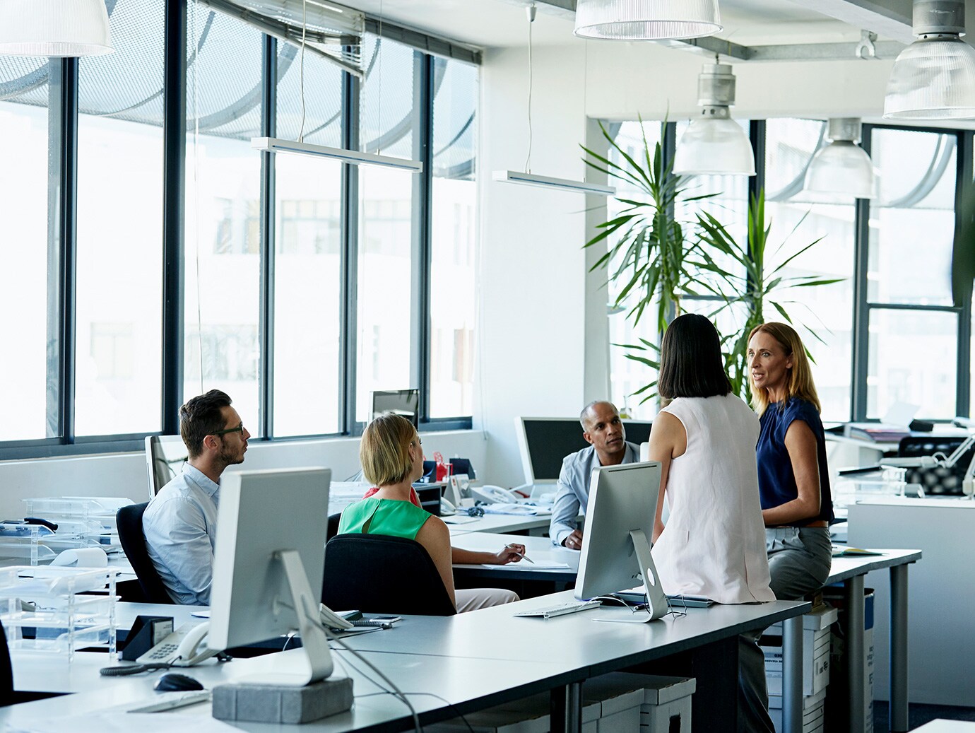 group of people talking in office