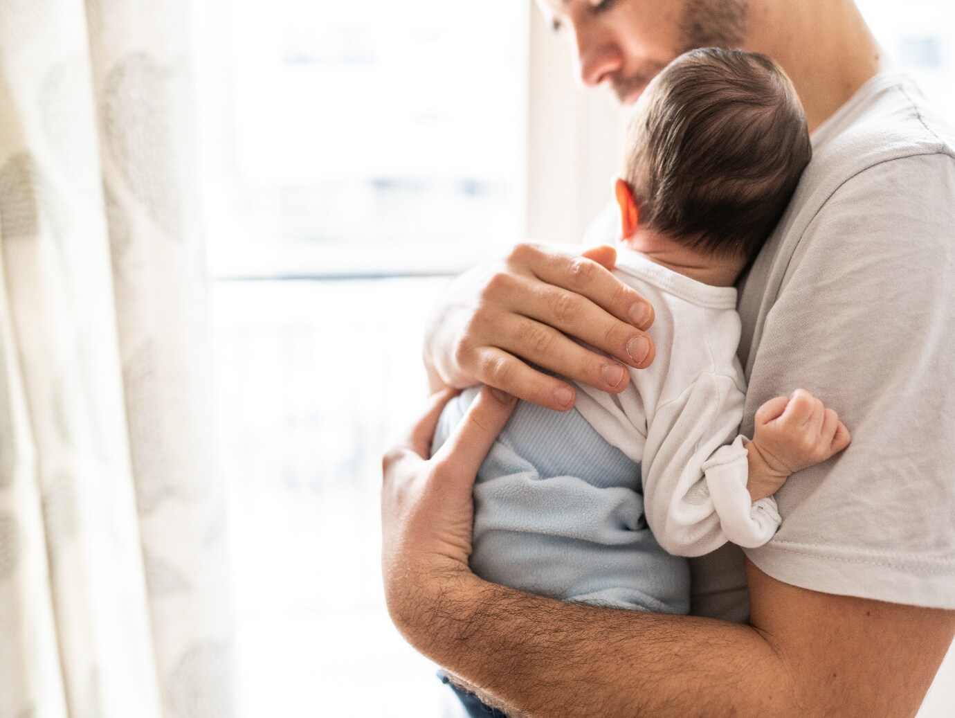 YORK Air Handler used in home for quiet and precise air circulation while father stands and holds newborn baby.