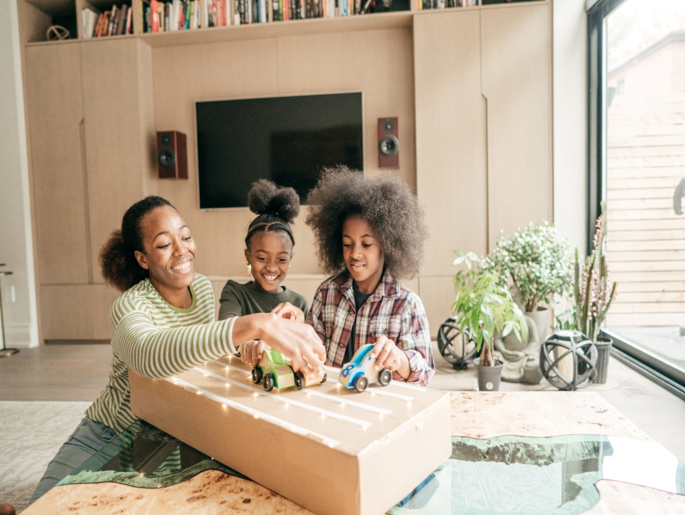 Home uses a YORK Packaged Unit to keep family comfortable while mother plays with her two daughters in the living room.